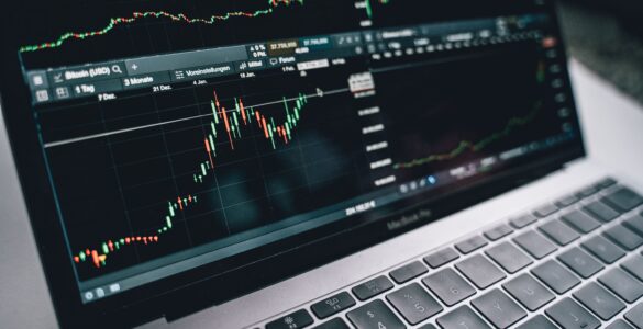 A laptop screen shows financial charts used to follow changing interest rate expectations.