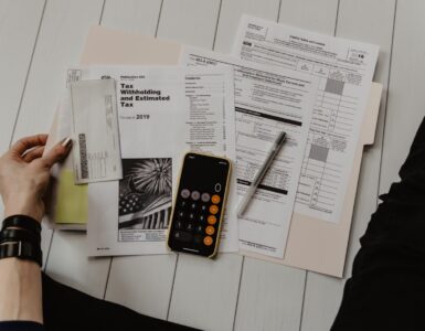 Calculator and financial paperwork used to estimate student loan repayment costs