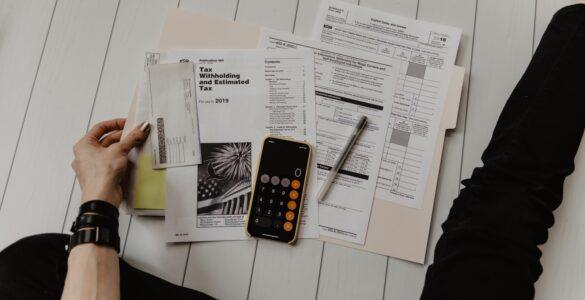 Calculator and financial paperwork used to compare college aid offers