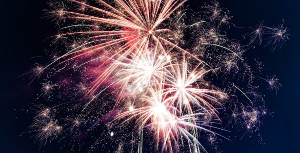 Bright fireworks bursting across a dark night sky
