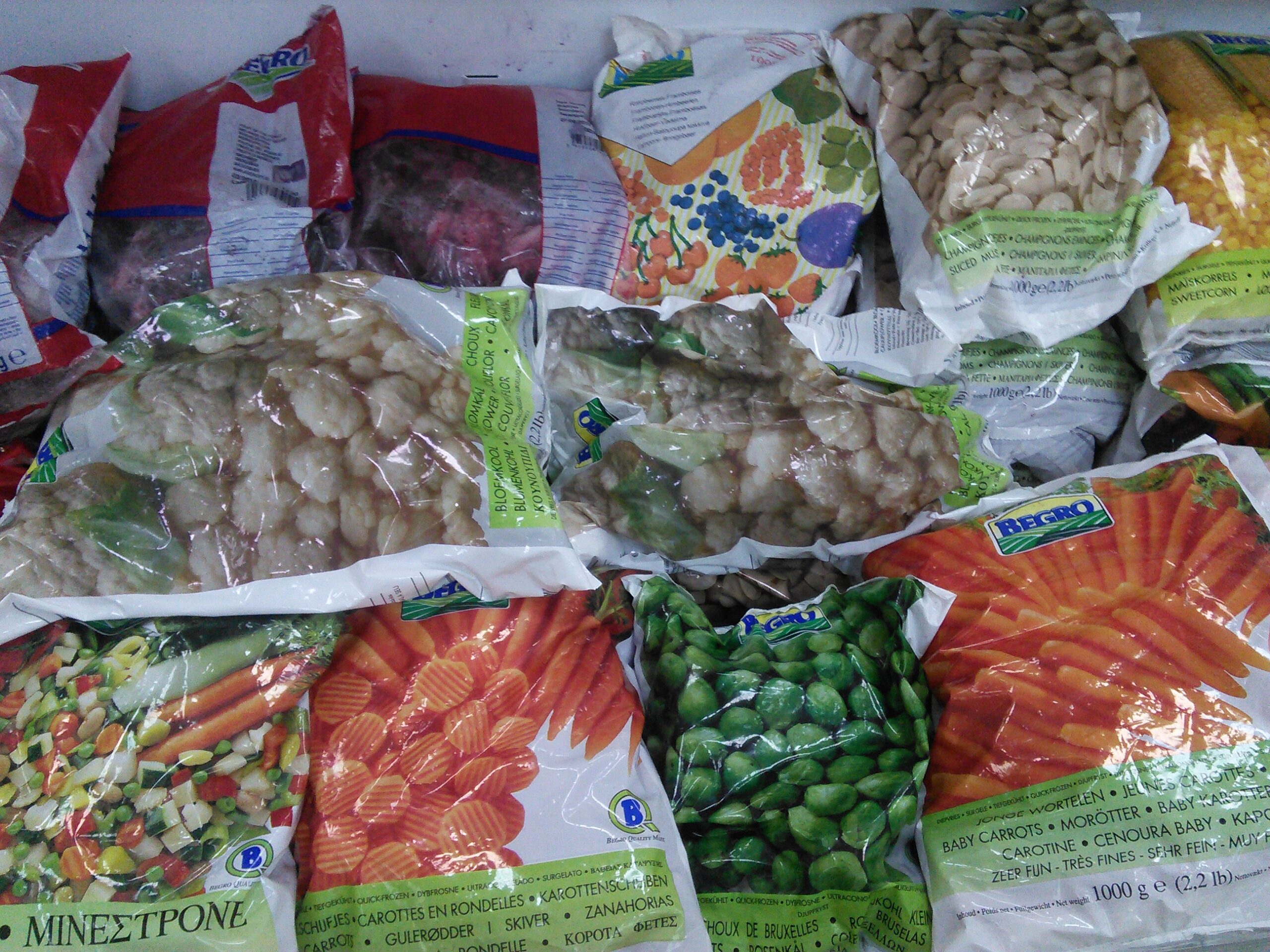 Bags of frozen vegetables stored together in a freezer