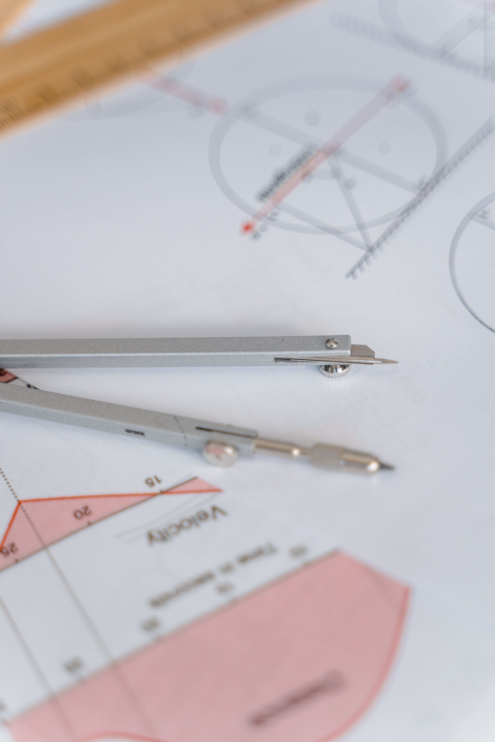 A compass and ruler resting on a geometry diagram