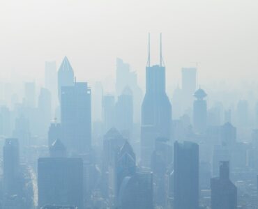 A city skyline partly hidden by pale haze