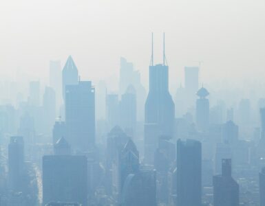 A city skyline partly hidden by pale haze