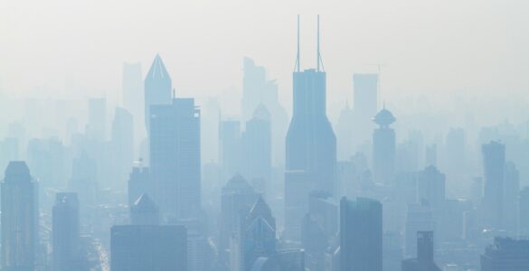 A city skyline partly hidden by pale haze