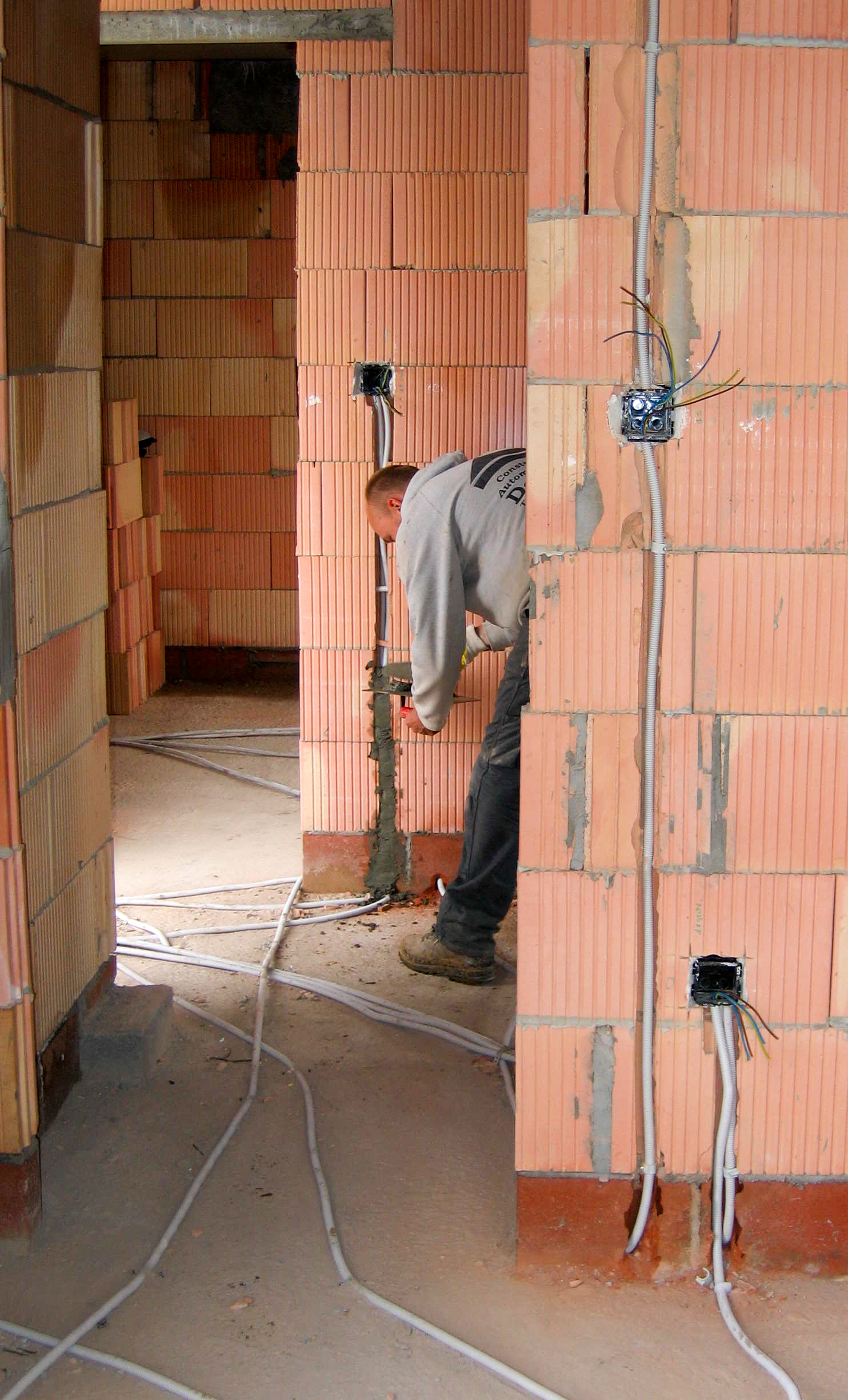 Electrical wiring being installed inside a wall opening