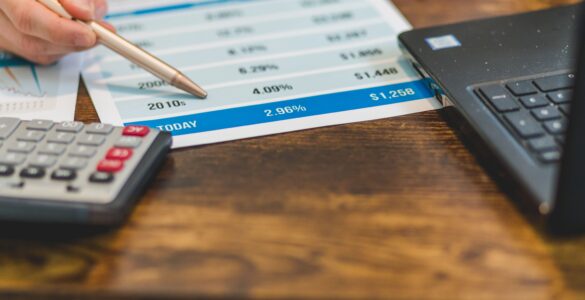A calculator beside paperwork showing interest rate figures for a real interest rate explanation.