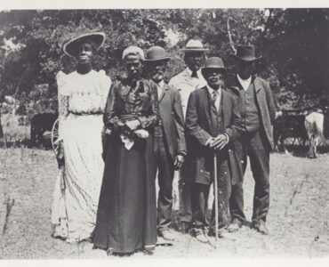 A group gathered outdoors for a Juneteenth Emancipation Day celebration in Texas in 1900.