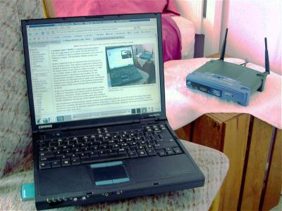 A laptop connected through a home wireless router, showing how devices share Wi-Fi airtime.