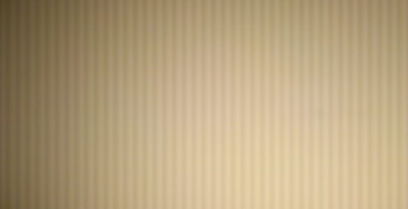 An LED lamp photographed with visible light and dark bands from camera rolling shutter flicker.