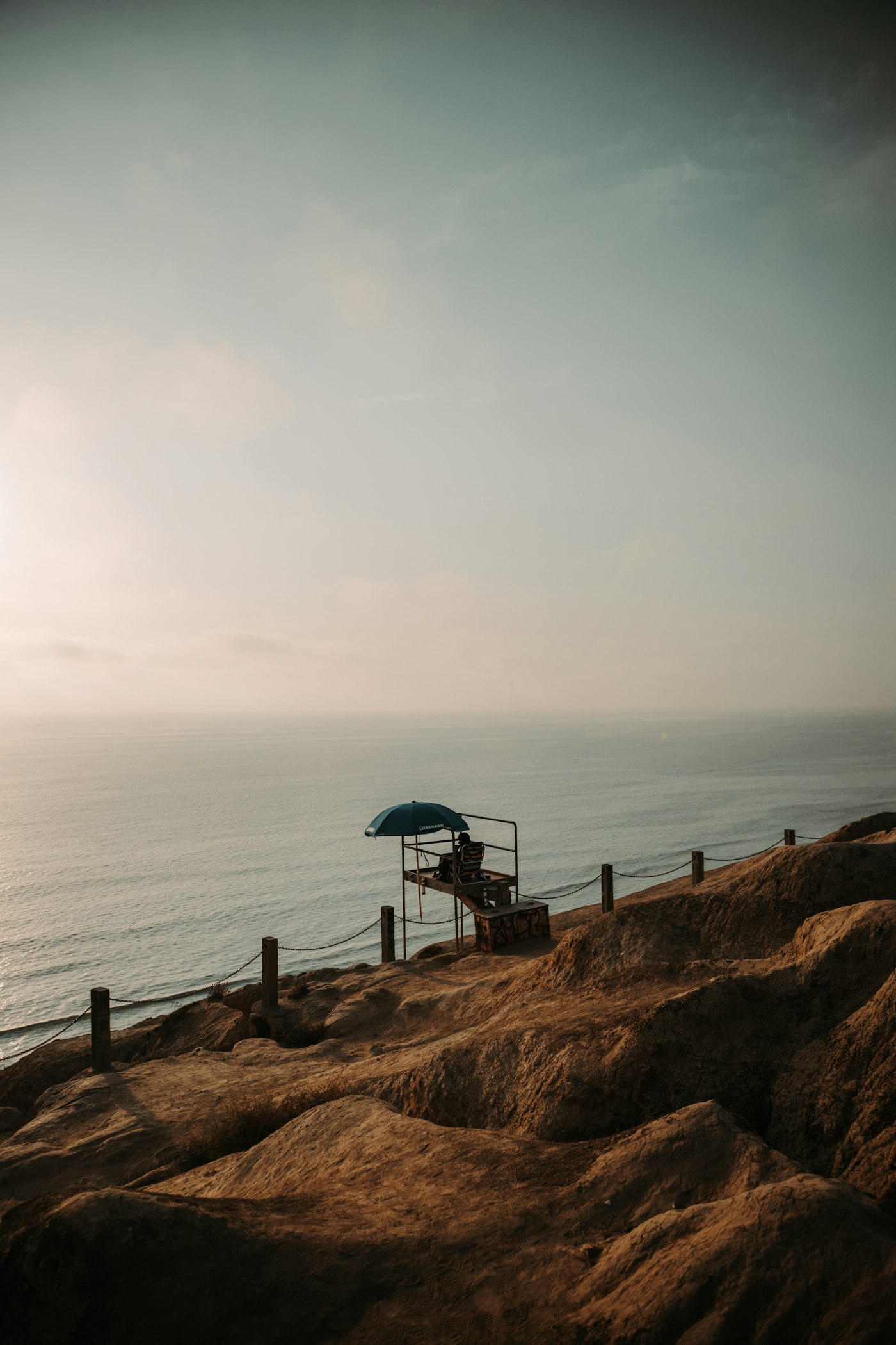 A lifeguard station overlooking the ocean from a coastal cliff.