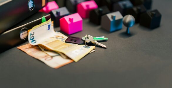 House keys, documents, and money arranged on a table for a mortgage payment explanation