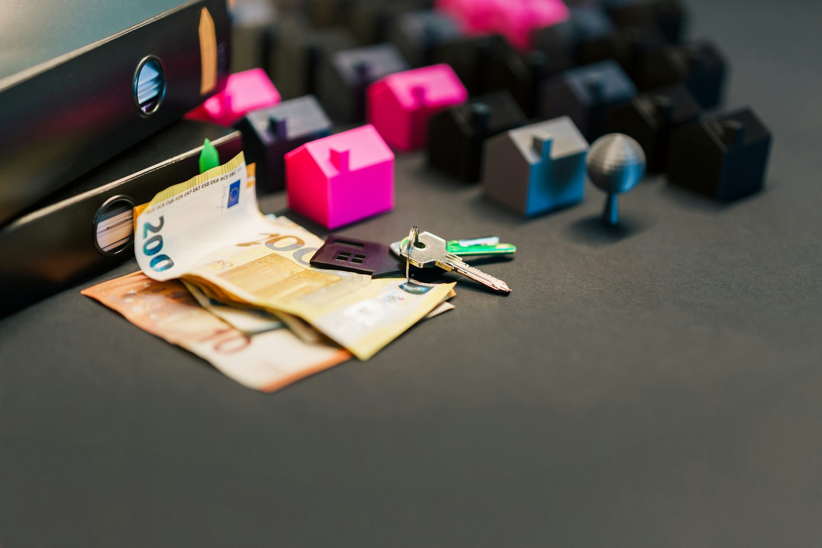 House keys, documents, and cash arranged on a table for a home loan decision