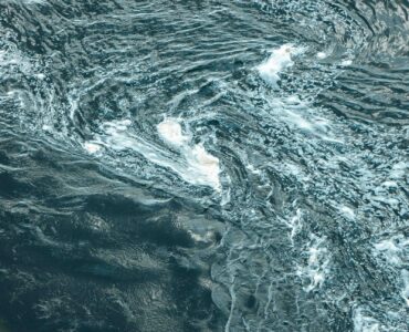 Aerial view of swirling blue ocean water showing current patterns