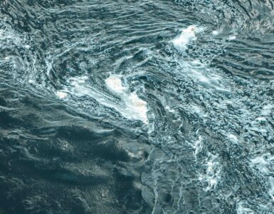 Aerial view of swirling blue ocean water showing current patterns