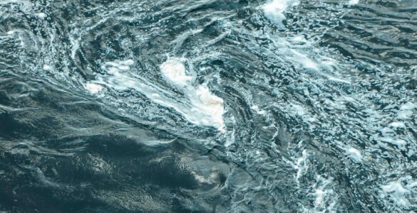 Aerial view of swirling blue ocean water showing current patterns