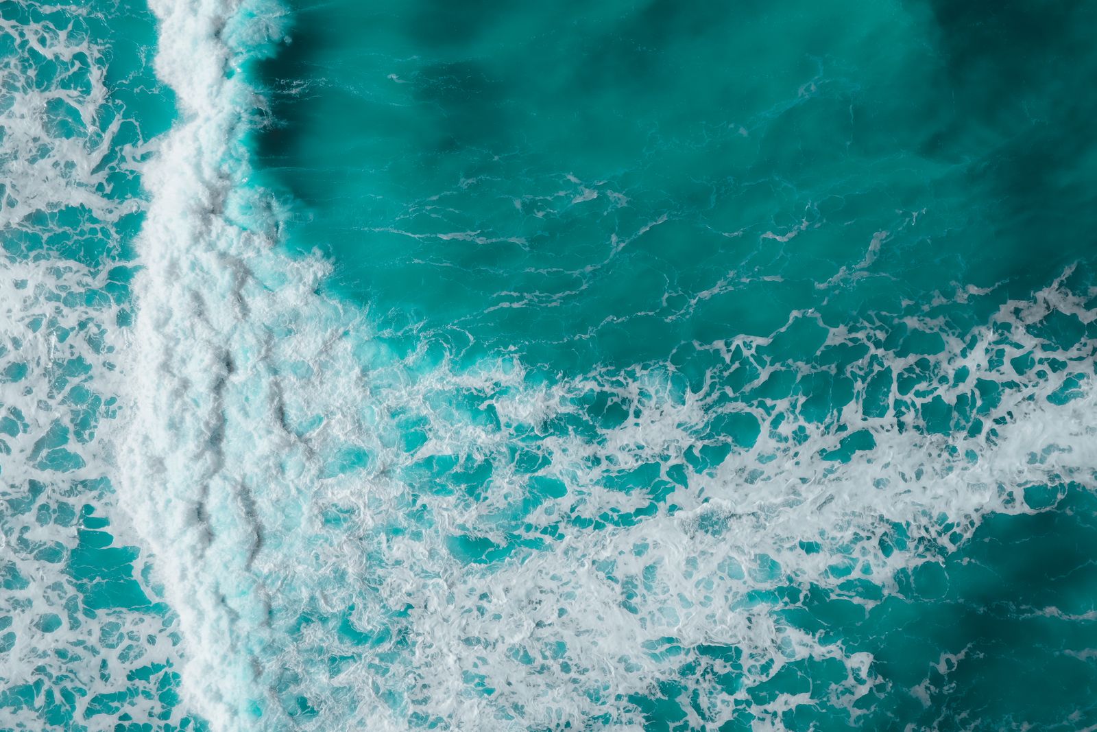 Aerial photograph of ocean waves and changing water textures