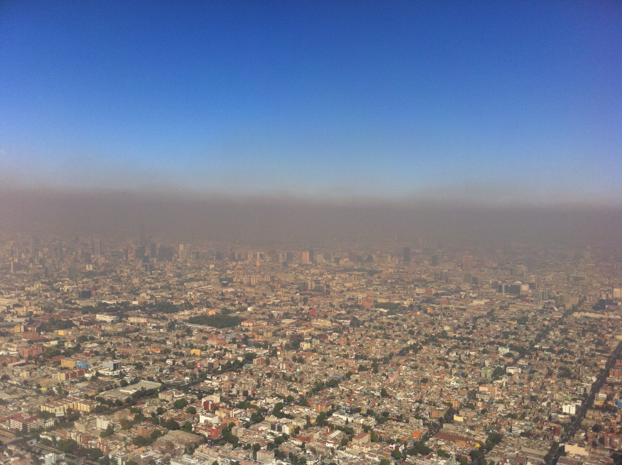 An aerial view of a city covered by photochemical smog