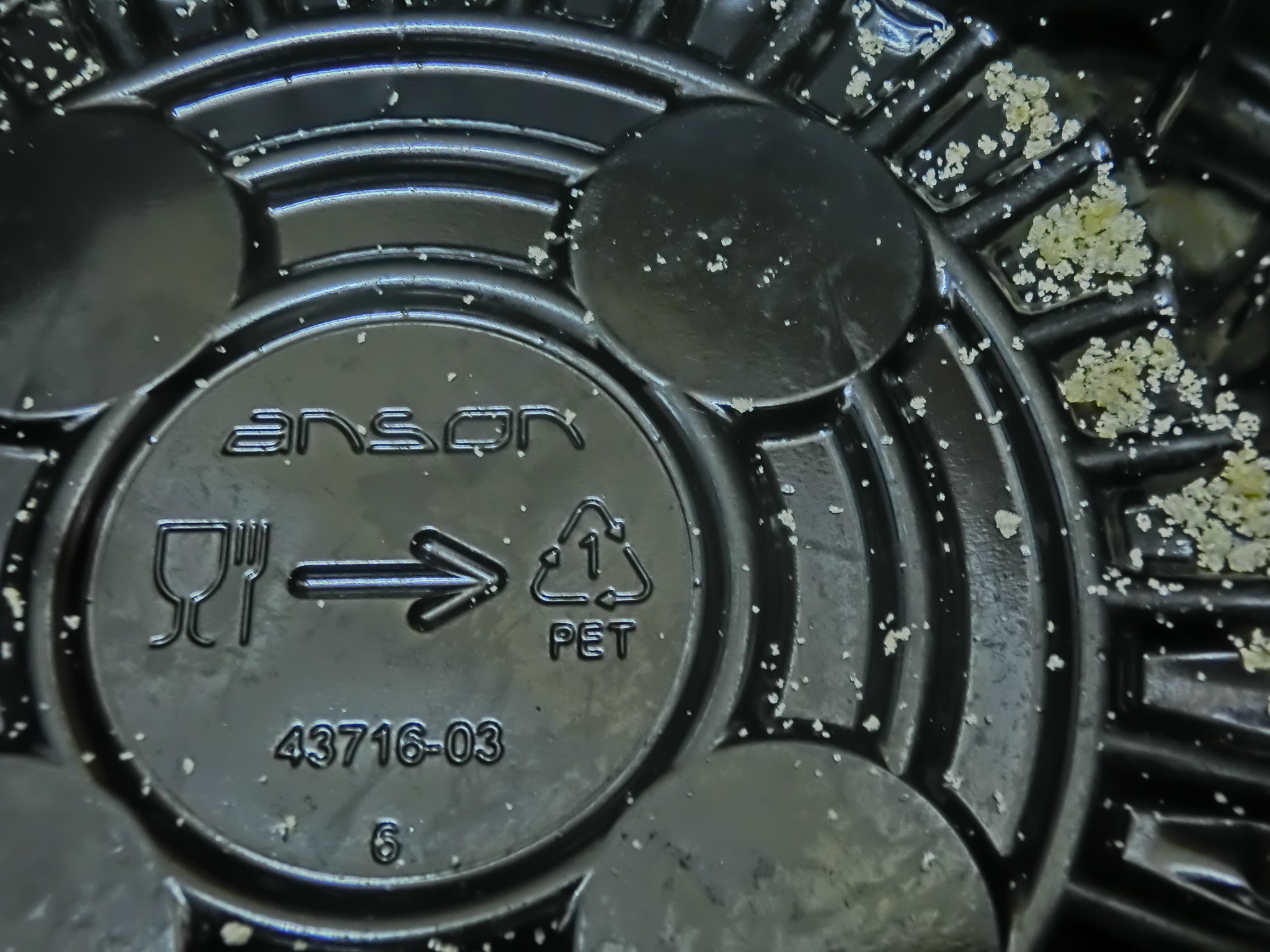 A resin identification code stamped on a plastic food container