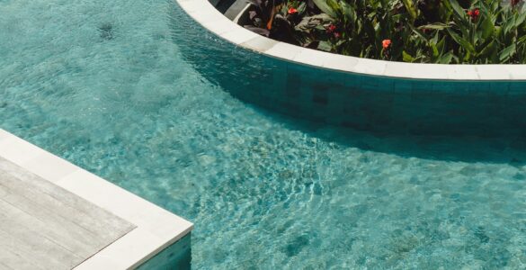 Clear outdoor swimming pool water in sunlight