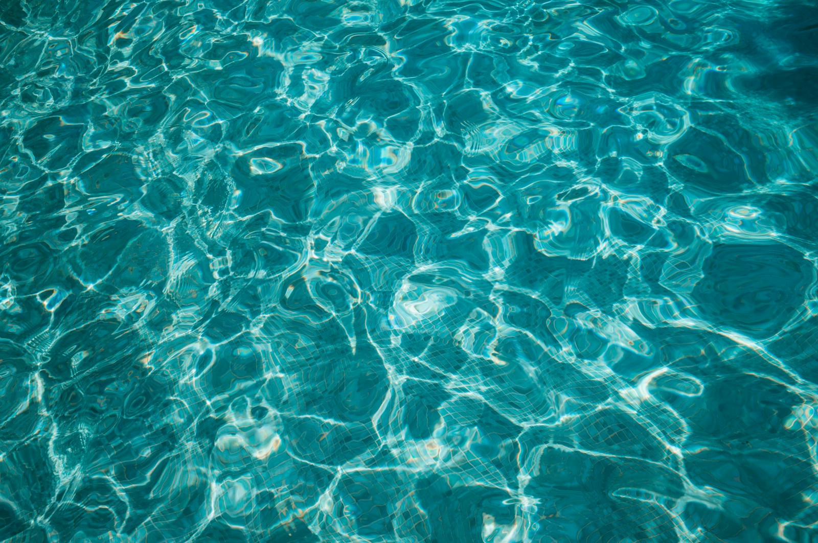 Clear blue pool water seen from above with gentle ripples