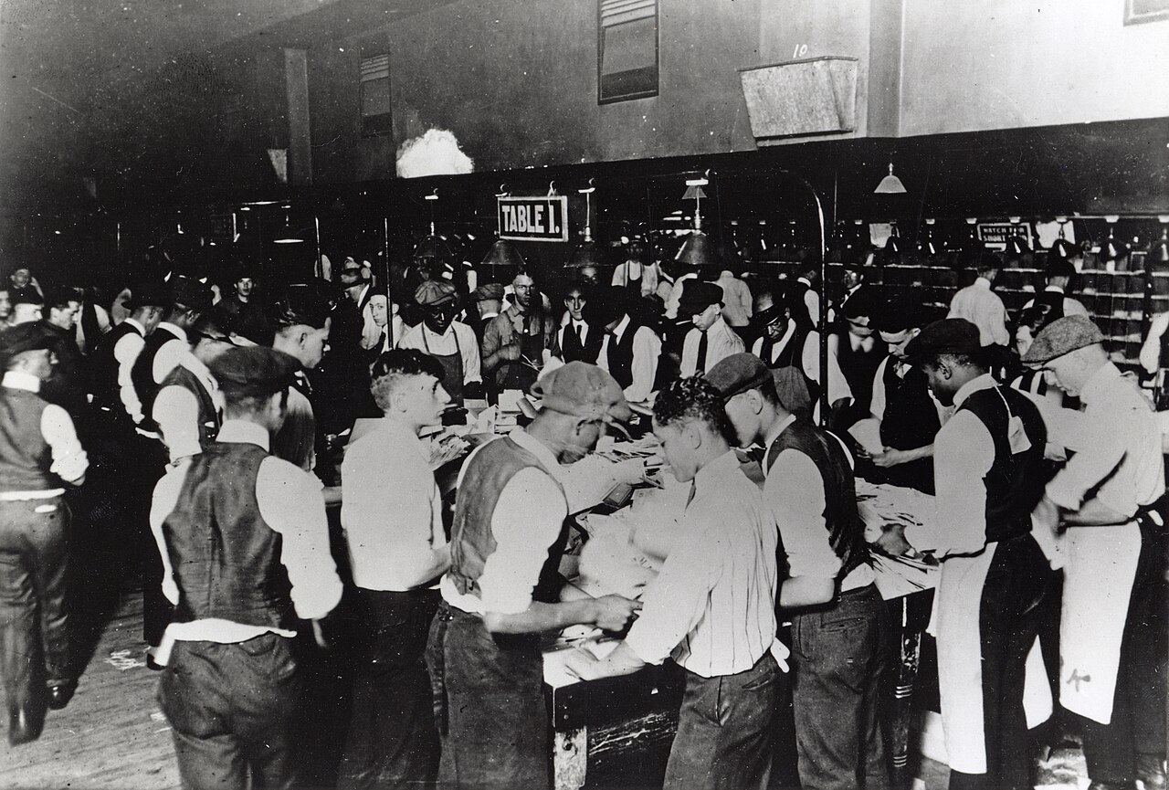 Postal clerks sorting mail by hand before modern automated mail processing
