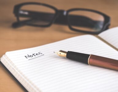 A notebook and pen used to prepare notes for a college recommendation letter request.
