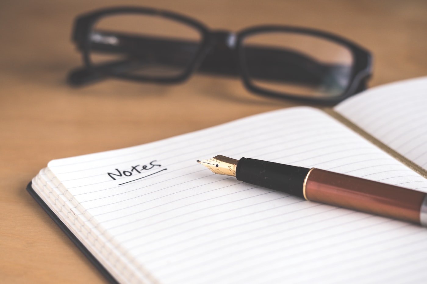 A notebook and pen used to prepare notes for a recommendation letter request.