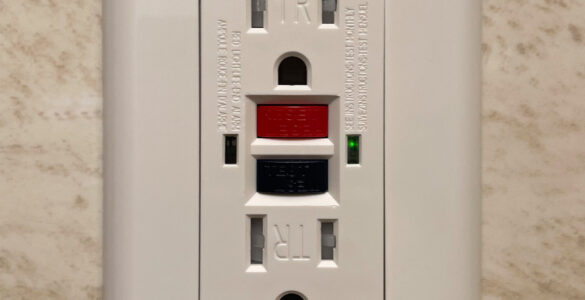 A residential GFCI outlet with test and reset buttons