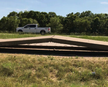 A section of concrete roadway buckled upward after sustained extreme heat.