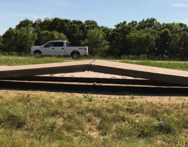 A section of concrete roadway buckled upward after sustained extreme heat.