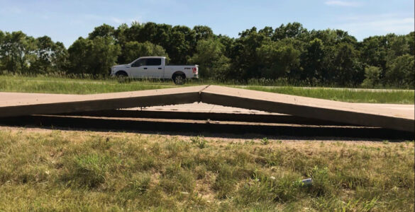 A section of concrete roadway buckled upward after sustained extreme heat.
