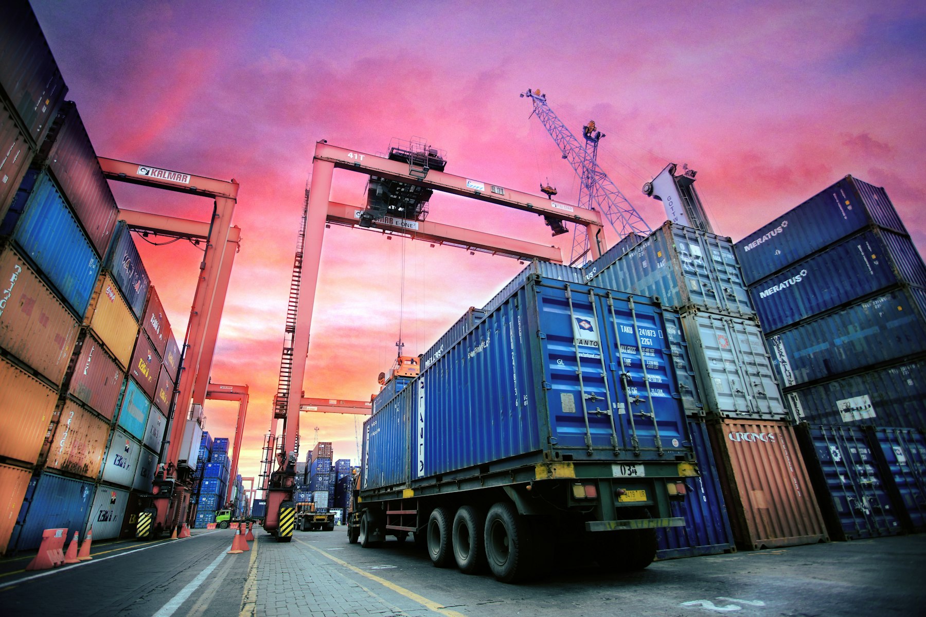 Shipping containers and a truck at a port where imported goods enter the customs system