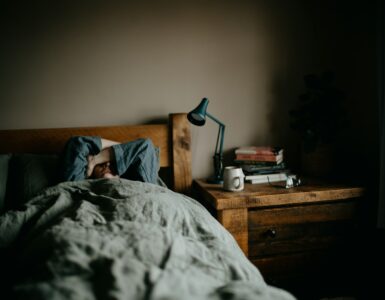 A person resting in bed in a quiet bedroom, representing sleep and dream recall.