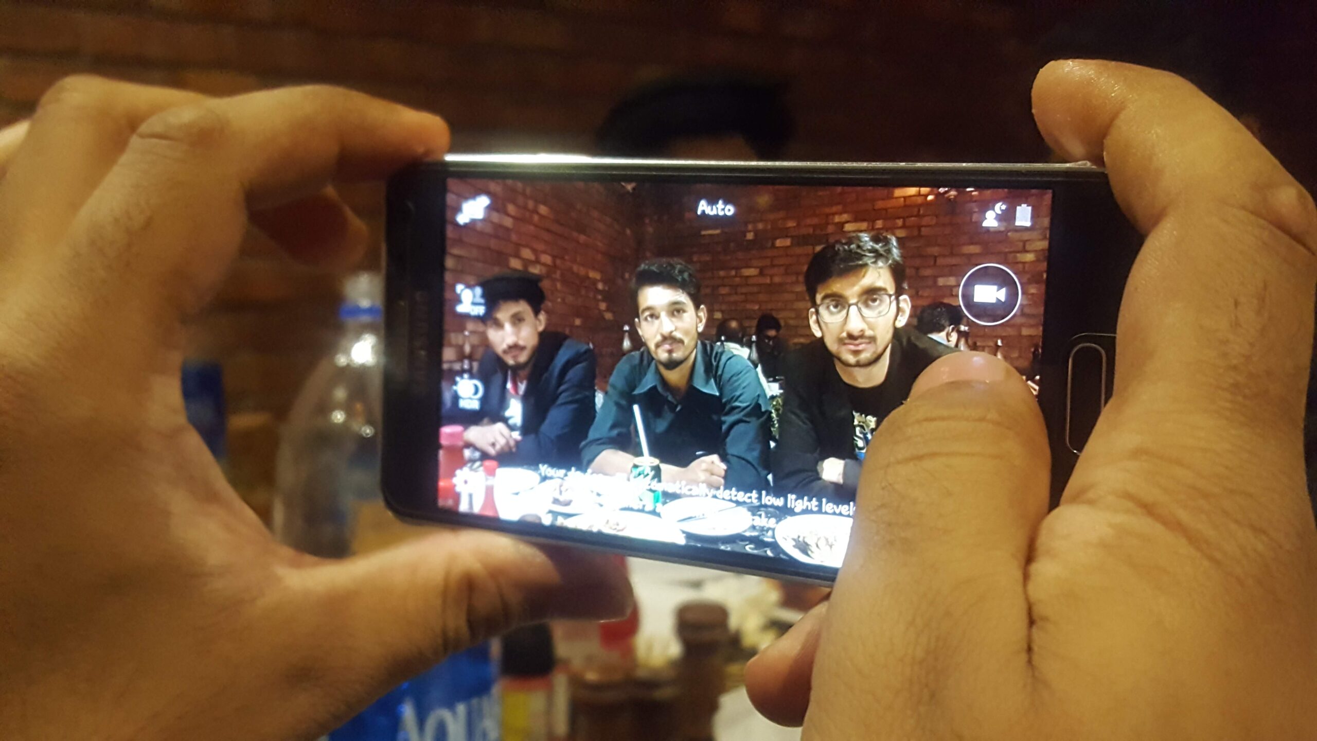 A smartphone camera being used indoors under artificial lighting.