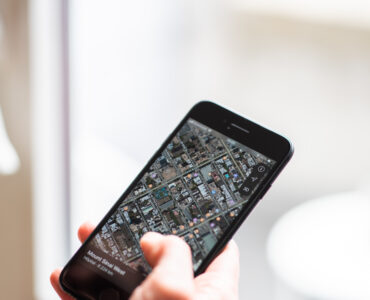 A smartphone showing a city map and directions, illustrating how phone navigation depends on location signals and map data.