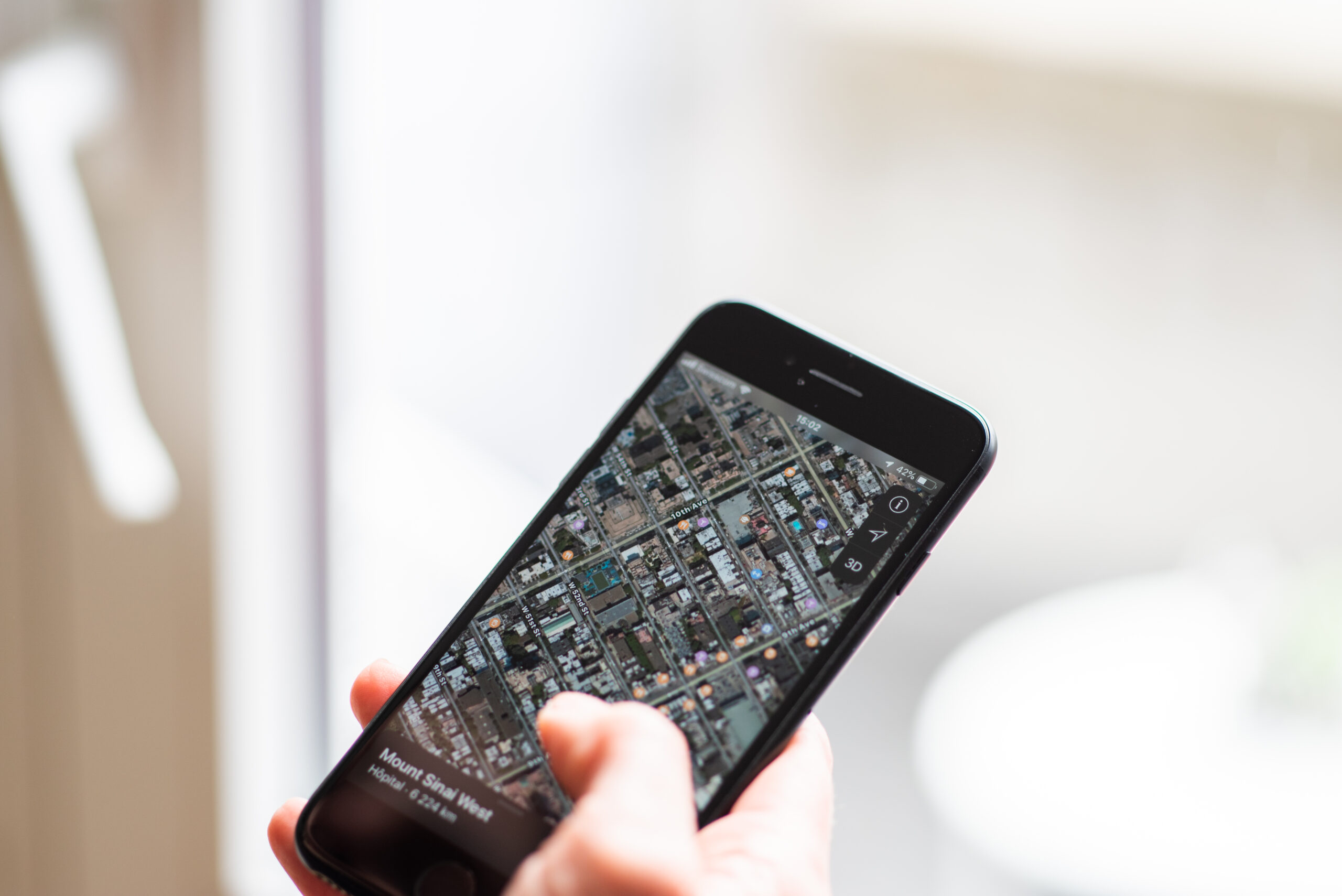 A smartphone showing city map directions, representing location data that can affect digital pricing