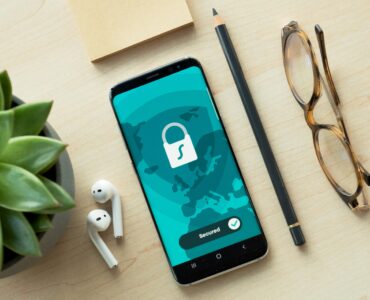 A smartphone showing a security lock screen on a desk.