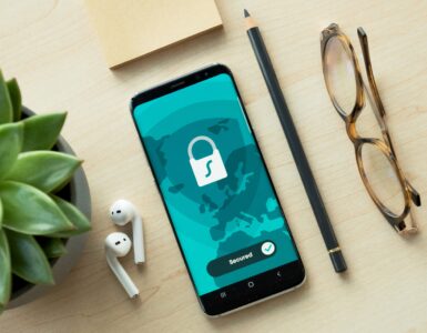 A smartphone showing a security lock screen on a desk.