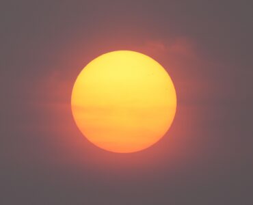A red Sun seen through smoky haze during a hazy sunrise