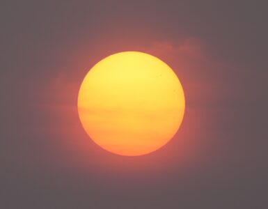 A red Sun seen through smoky haze during a hazy sunrise