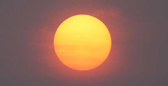 A red Sun seen through smoky haze during a hazy sunrise
