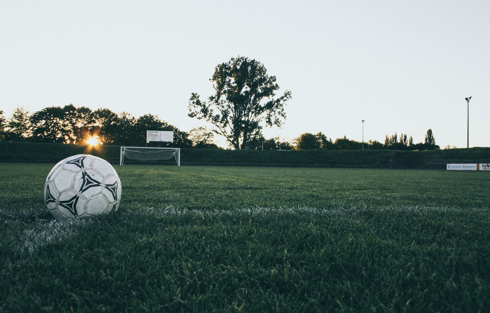 A soccer goal net on a field, representing knockout-round pressure