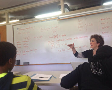 Students in a Spanish language class reviewing sentences together