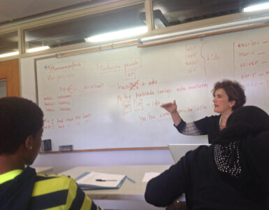 Students in a Spanish language class reviewing sentences together