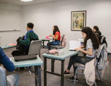 Students studying and taking notes in a language classroom
