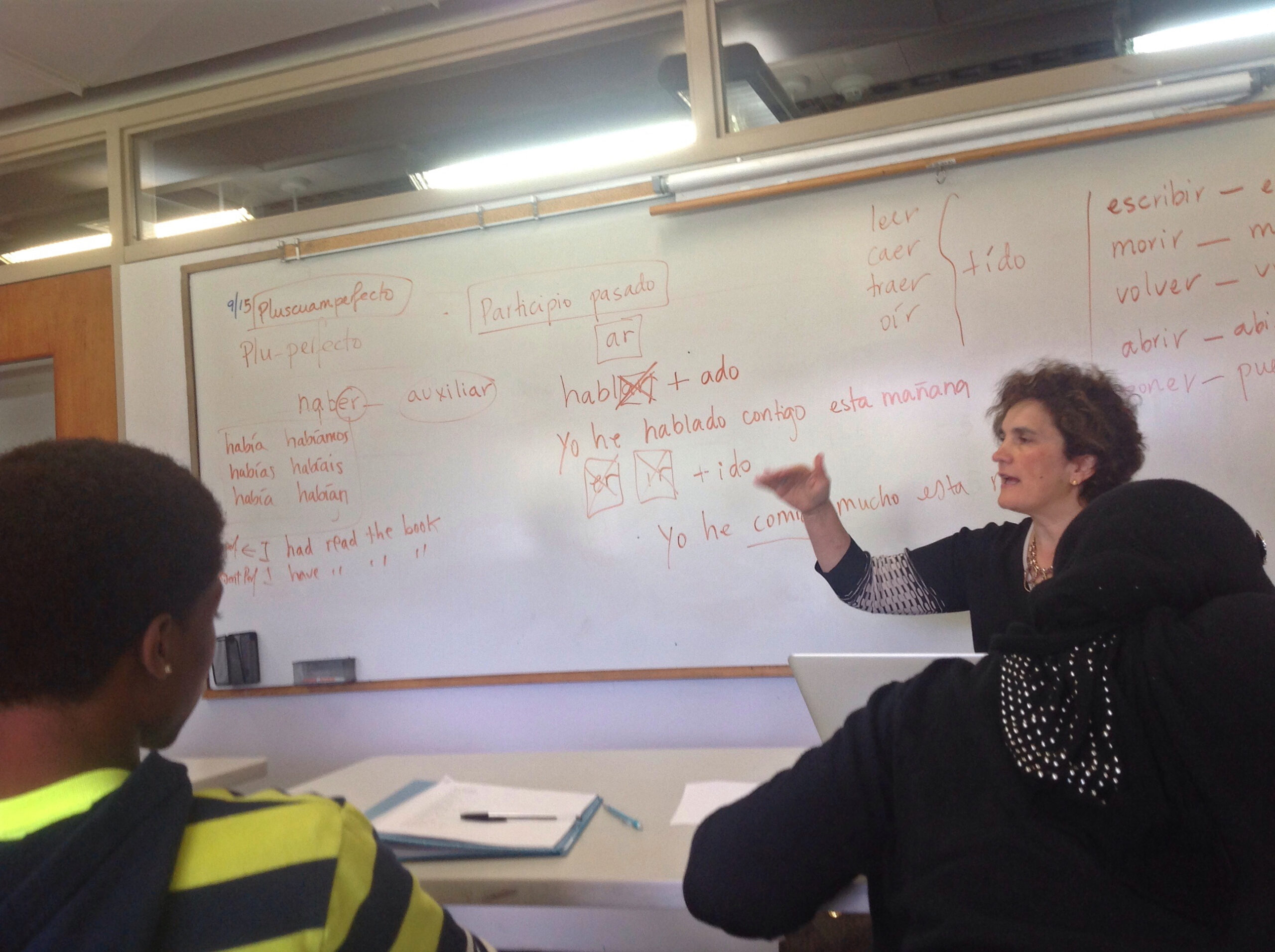 Students discussing Spanish vocabulary examples in a language class