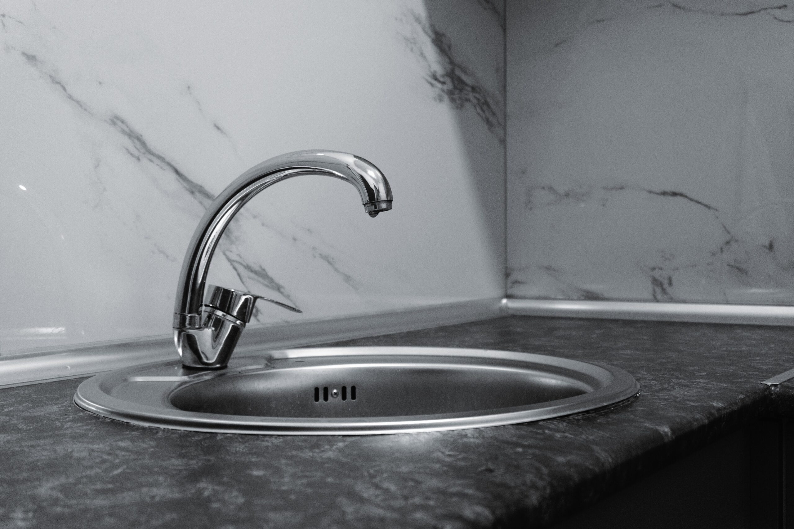 A clean kitchen sink and faucet where tap water may need boiling during an advisory