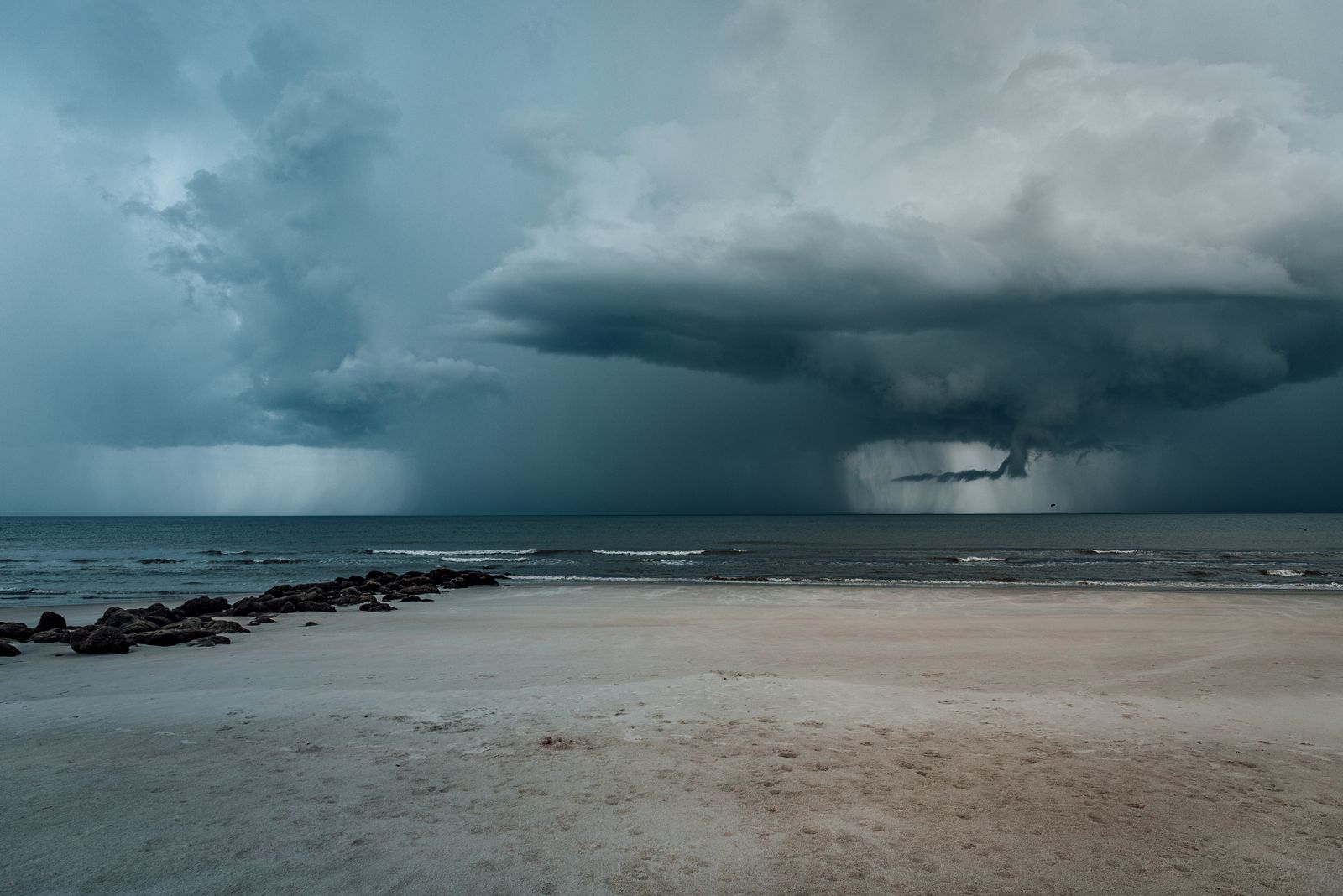 Dark storm clouds gathering over the ocean as forecasters track tropical weather.