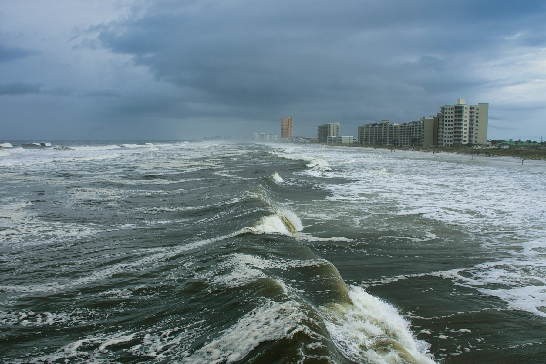Storm-driven waves along a coast showing how wind leaves visible clues on water.
